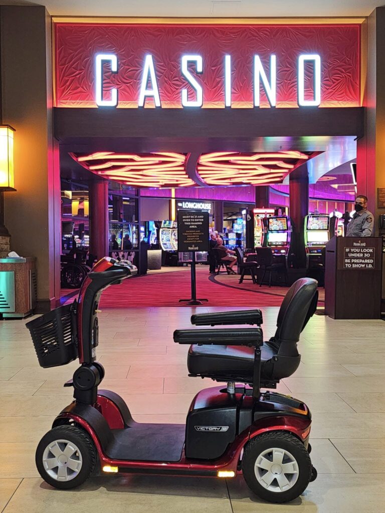 A red Mobility scooter parked in front of a sign that says Casino