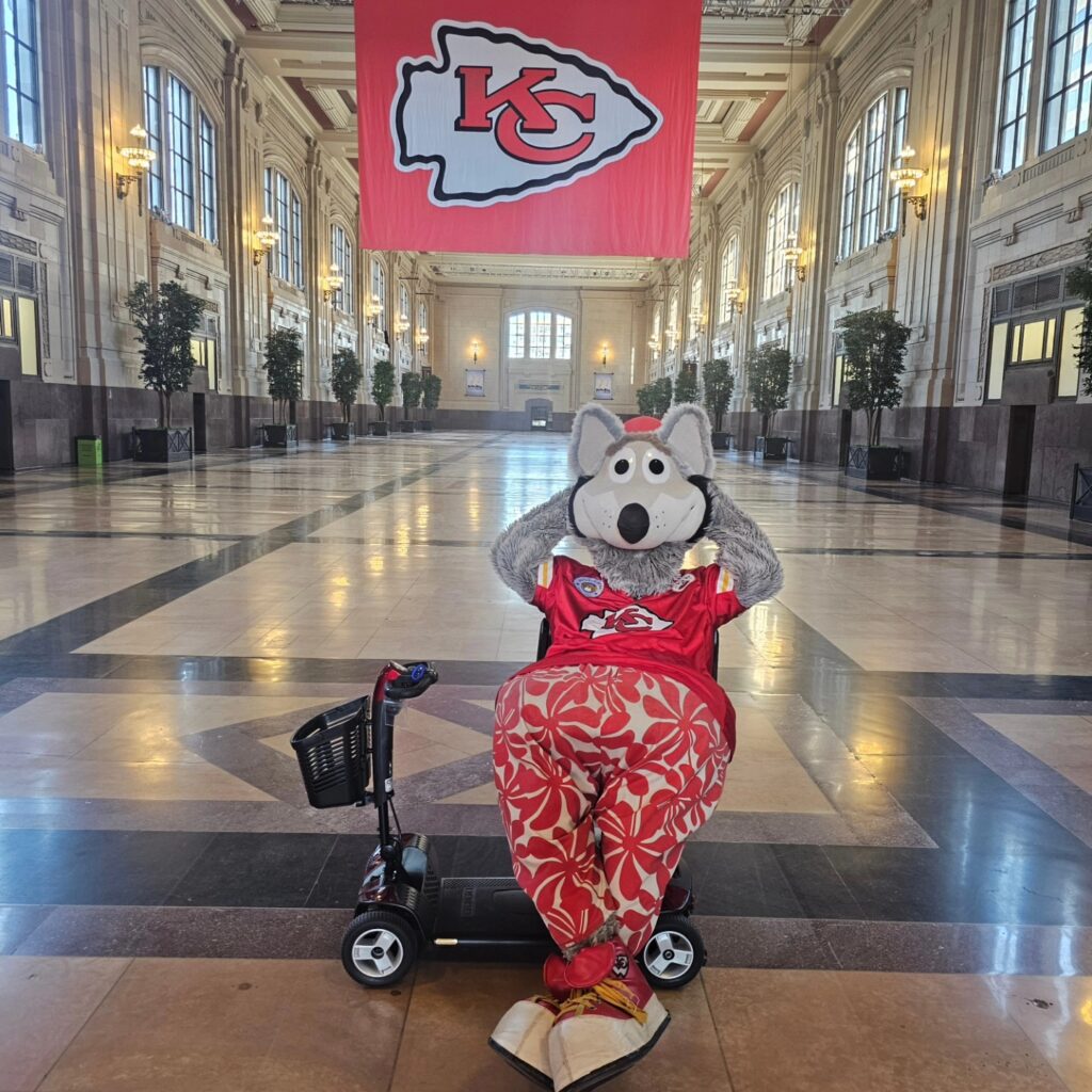 Kansas City Chief's Mascot KC Wolf sitting on a Mobility Scooter